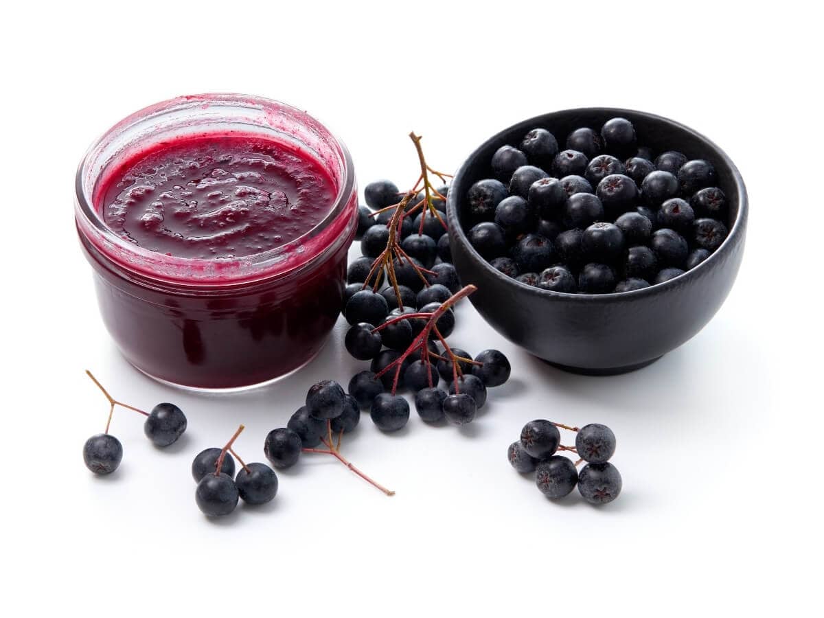 Fresh Aronia berries in bowl and aronia berry jam