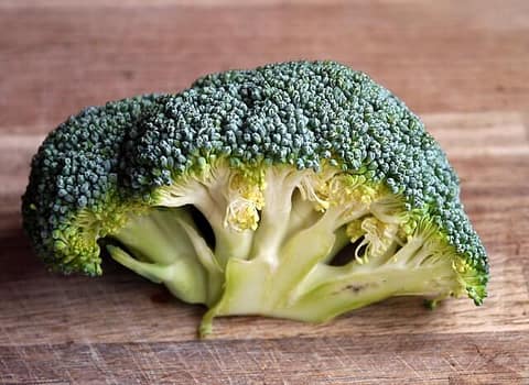 broccoli on wooden cutting board
