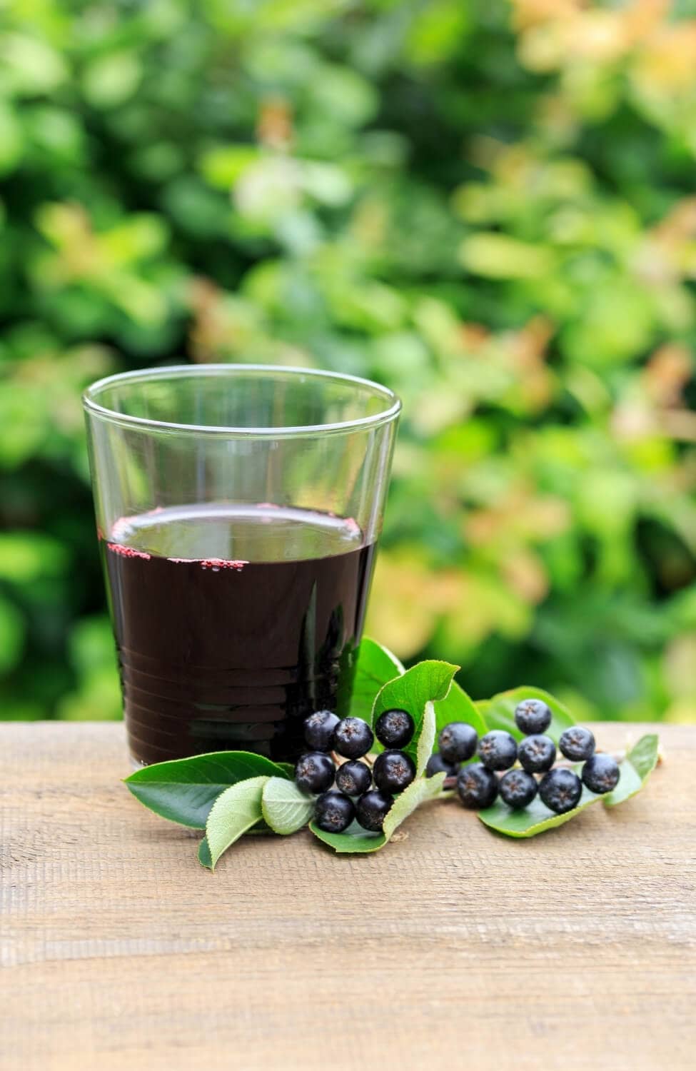 Aronia berries and juice in glass